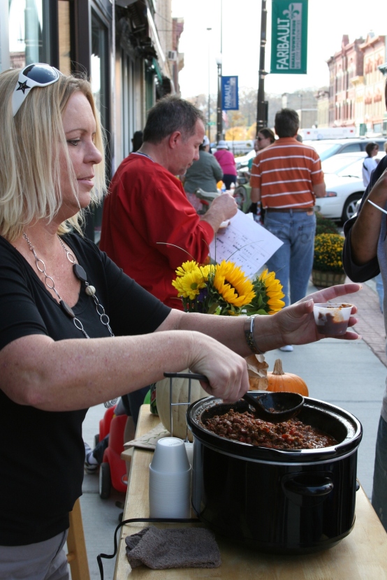 Christine Henke serves chili, which I classified as "very spicy" at Glam Central Salon.