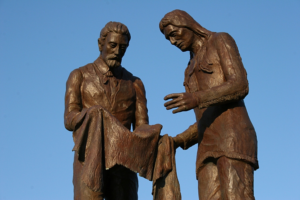 This sculptor of Alexander Faribault trading with a Dakota trading partner stands in Faribault's Heritage Park near the Straight River and site of Faribault's trading post. Faribault artist Ivan Whillock created this sculpture which sits atop a fountain known as the Bea Duncan Memorial Fountain.