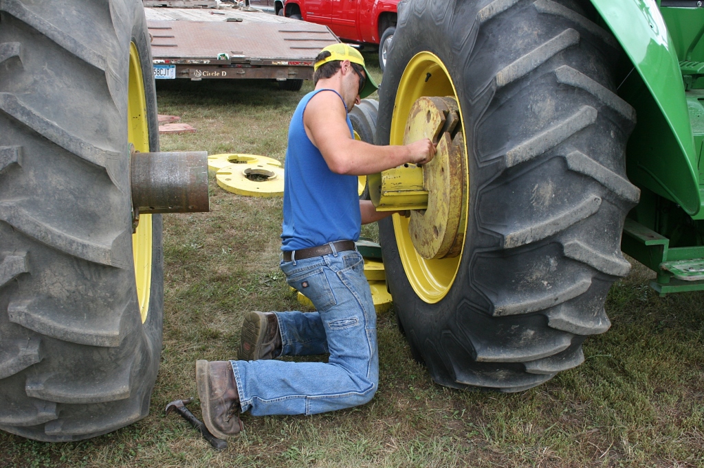 Adding 100-pound wheel weights for the tractor pull.