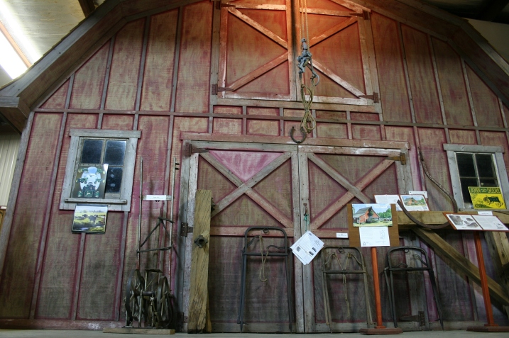 A barn front forms a backdrop in Harvest Hall, where visitors can learn about the area's agricultural heritage.