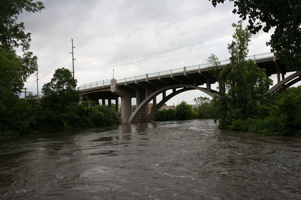 The Straight River has flooded Teepee Tonka Park and churns here toward the Highway 60 viaduct connecting the east and west sides of Faribault.