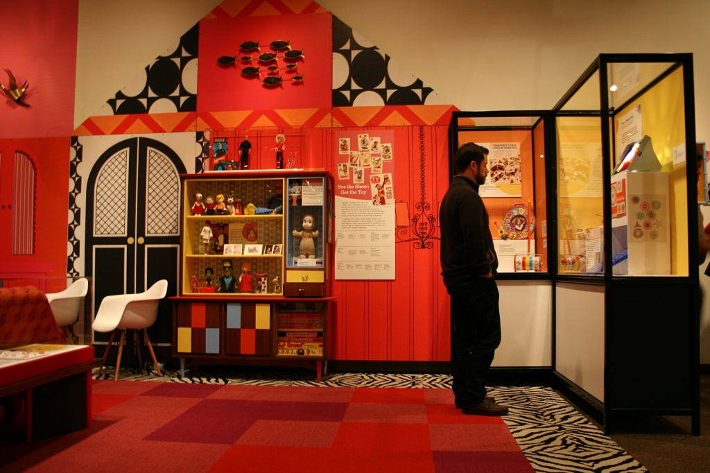 A museum visitor checks out the 1960s exhibit.