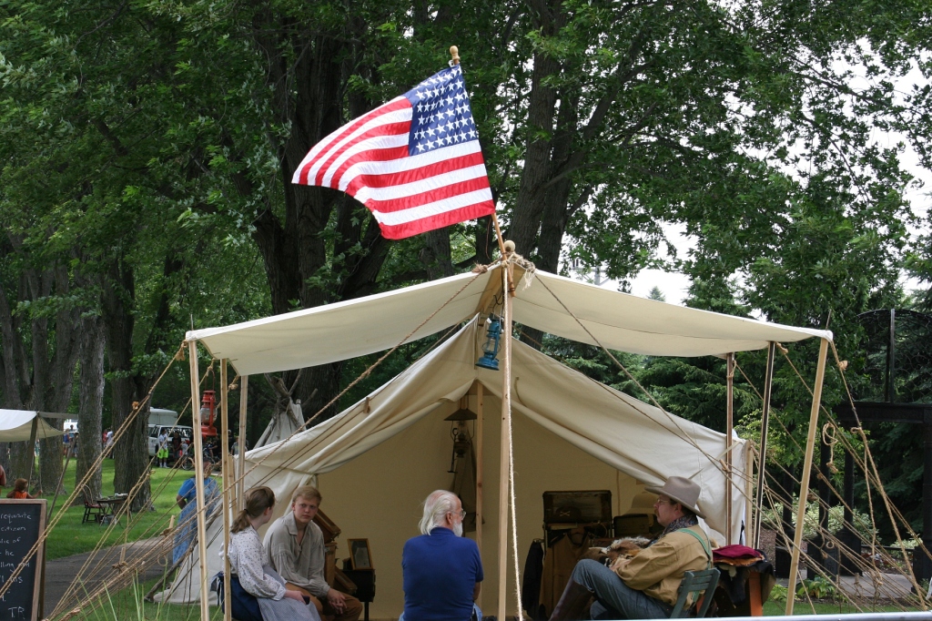 Sunday afternoon in Elysian, a flag flies over a tent on the Trails of History event.