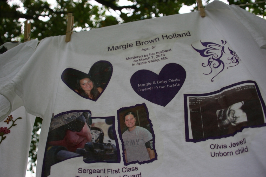 Margie Brown Holland and her unborn daughter, Olivia, were honored at The Clothesline Project display this summer in Owatonna. The Minnesota Coalition for Battered Women coordinates the project to honor victims of domestic violence. Redeemer Lutheran Church brought the project to Owatonna this past summer. 
