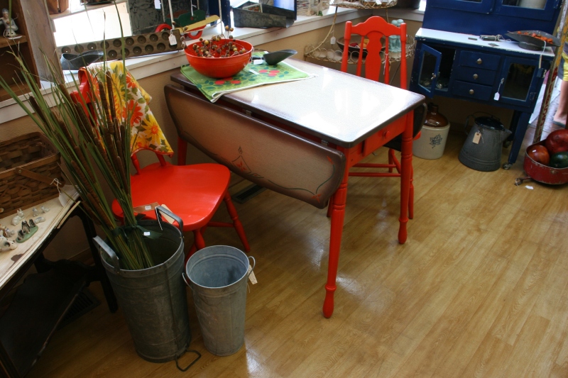A unique table that punches color combined with orange chairs.