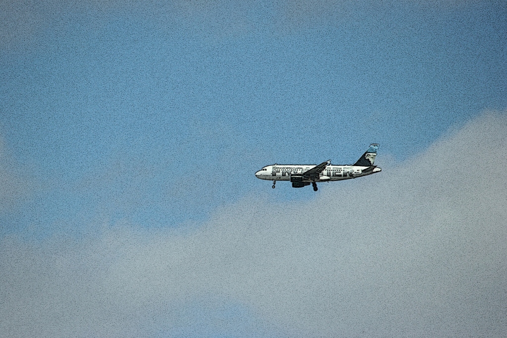 I photographed this Frontier plane as it approached Minneapolis-St. Paul International Airport early Saturday afternoon. Edited image.